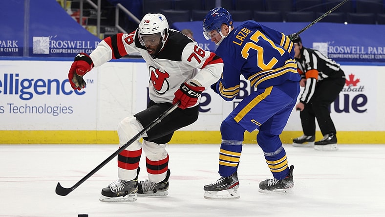 Jan 30, 2021; Buffalo, New York, USA;  New Jersey Devils defenseman P.K. Subban (76) skates with the puck as Buffalo Sabres center Curtis Lazar (27) tries to defend during the second period at KeyBank Center. Mandatory Credit: Timothy T. Ludwig-USA TODAY Sports