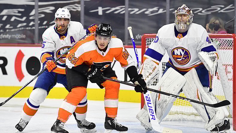 Jan 30, 2021; Philadelphia, Pennsylvania, USA; New York Islanders right wing Cal Clutterbuck (15) checks Philadelphia Flyers center Connor Bunnaman (82) in front of goaltender Semyon Varlamov (40) during the second period at Wells Fargo Center. Mandatory Credit: Eric Hartline-USA TODAY Sports