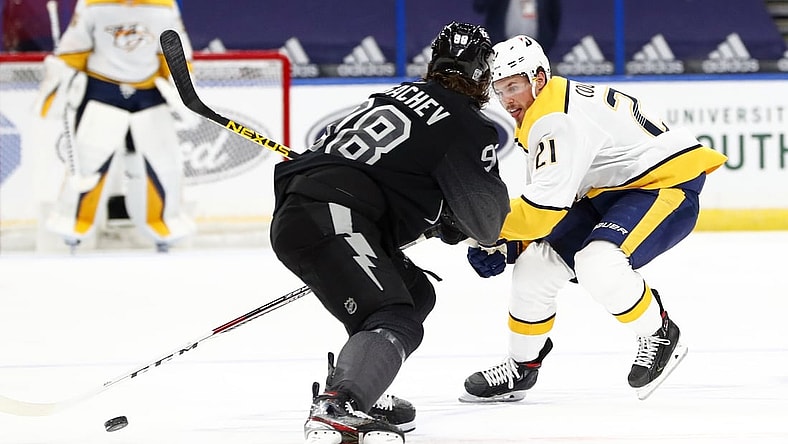 Jan 30, 2021; Tampa, Florida, USA; Nashville Predators center Nick Cousins (21) skates with the puck as Tampa Bay Lightning defenseman Mikhail Sergachev (98) defends during the second period at Amalie Arena. Mandatory Credit: Kim Klement-USA TODAY Sports