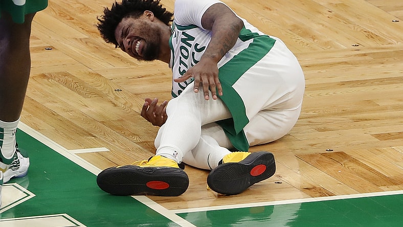 Jan 30, 2021; Boston, Massachusetts, USA; Boston Celtics guard Marcus Smart (36) grabs for his left leg after being injured during the fourth quarter against the Los Angeles Lakers at TD Garden. Mandatory Credit: Winslow Townson-USA TODAY Sports