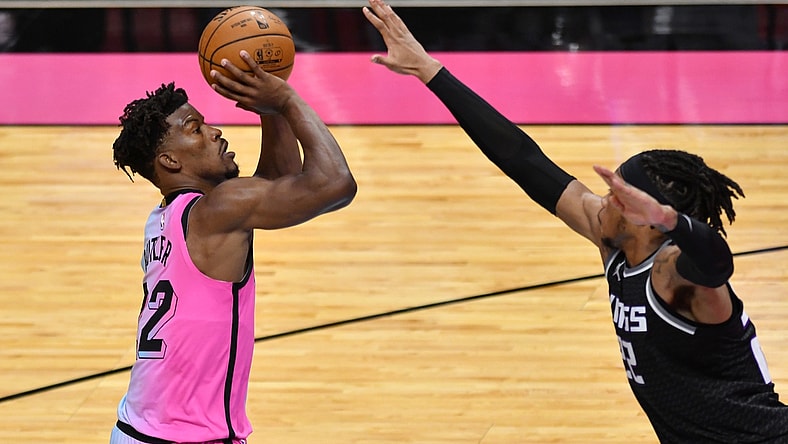 Jan 30, 2021; Miami, Florida, USA; Miami Heat forward Jimmy Butler (22) takes a shot over Sacramento Kings center Richaun Holmes (22) in the fourth quarter at American Airlines Arena. Mandatory Credit: Jim Rassol-USA TODAY Sports