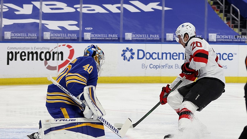 Jan 31, 2021; Buffalo, New York, USA; New Jersey Devils center Michael McLeod (20) scores a goal on Buffalo Sabres goaltender Carter Hutton (40) during the first period at KeyBank Center. Mandatory Credit: Timothy T. Ludwig-USA TODAY Sports