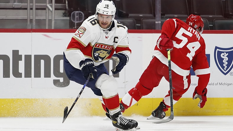 Jan 31, 2021; Detroit, Michigan, USA; Florida Panthers center Aleksander Barkov (16) skates to the puck against Detroit Red Wings right wing Bobby Ryan (54) during the second period at Little Caesars Arena. Mandatory Credit: Raj Mehta-USA TODAY Sports