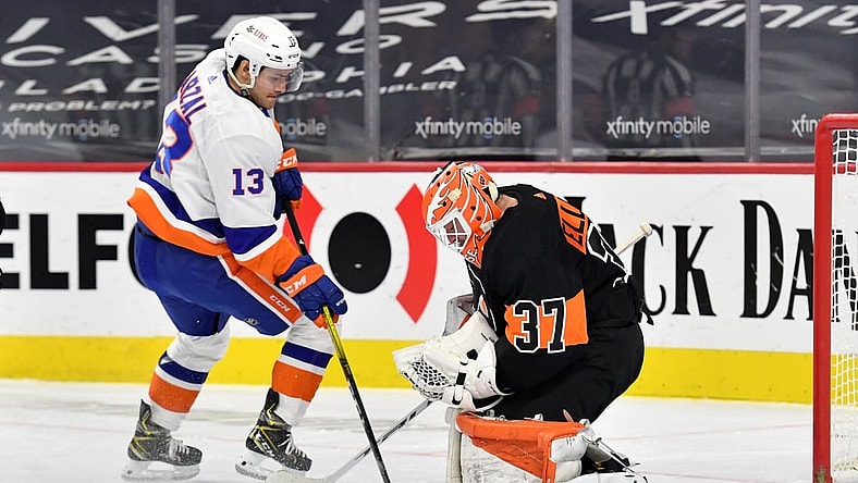 Jan 31, 2021; Philadelphia, Pennsylvania, USA; Philadelphia Flyers goaltender Brian Elliott (37) covers the puck against New York Islanders center Mathew Barzal (13) during the first period at Wells Fargo Center. Mandatory Credit: Eric Hartline-USA TODAY Sports