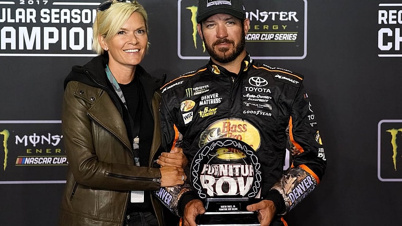 Sep 9, 2017; Richmond, VA, USA; NASCAR Cup Series driver Martin Truex Jr. (78) and his girlfriend Sherry Pollex pose with the NASCAR regular season trophy after the Federated Auto Parts 400 at Richmond International Raceway. Mandatory Credit: Peter Casey-USA TODAY Sports