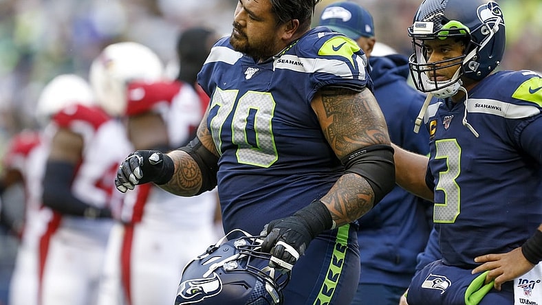Dec 22, 2019; Seattle, Washington, USA; Seattle Seahawks offensive guard Mike Iupati (70) walks off the field with quarterback Russell Wilson (3) following a first quarter injury against the Arizona Cardinals at CenturyLink Field. Mandatory Credit: Joe Nicholson-USA TODAY Sports