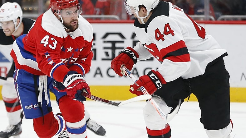 Jan 16, 2020; Washington, District of Columbia, USA; Washington Capitals right wing Tom Wilson (43) slashes New Jersey Devils left wing Miles Wood (44) in the first period at Capital One Arena. Mandatory Credit: Geoff Burke-USA TODAY Sports