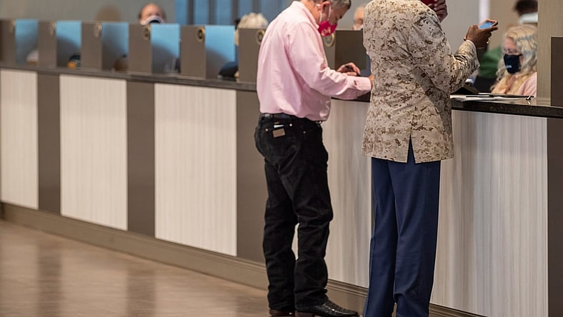 Sep 4, 2020; Louisville, Kentucky, USA; Two men bet on the second floor of Churchill Downs on Kentucky Oaks day.  Mandatory Credit: Pat McDonogh/Louisville Courier-Journal-USA TODAY NETWORK