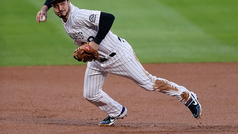 Sep 11, 2020; Denver, Colorado, USA; Colorado Rockies third baseman Nolan Arenado (28) fields and throws to first base in the first inning against the Los Angeles Angels at Coors Field. Mandatory Credit: Isaiah J. Downing-USA TODAY Sports