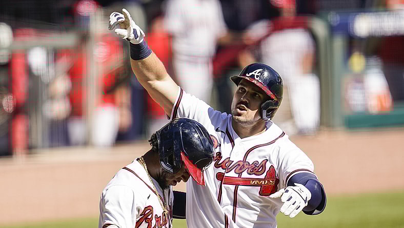 Oct 1, 2020; Cumberland, Georgia, USA; Atlanta Braves left fielder Adam Duvall (23) reacts with second baseman Ozzie Albies (1) after hitting a two run home run against the Cincinnati Reds during the eighth inning at Truist Park. Mandatory Credit: Dale Zanine-USA TODAY Sports