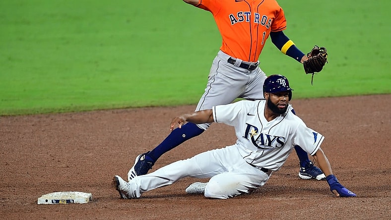 Oct 17, 2020; San Diego, California, USA; Tampa Bay Rays center fielder Manuel Margot (13) is out at second as Houston Astros shortstop Carlos Correa (1) throws to first during the fifth inning  in game seven of the 2020 ALCS at Petco Park. Mandatory Credit: Jayne Kamin-Oncea-USA TODAY Sports