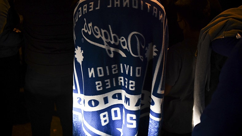 Oct 27, 2020; Los Angeles, California, USA; Fans on Whittier Blvd. in East Los Angeles celebrate the Los Angeles Dodgers winning their first World Series title since 1988. The Dodgers beat the Tampa Bay Rays in Game 6 to win.. Mandatory Credit: Harrison Hill-USA TODAY