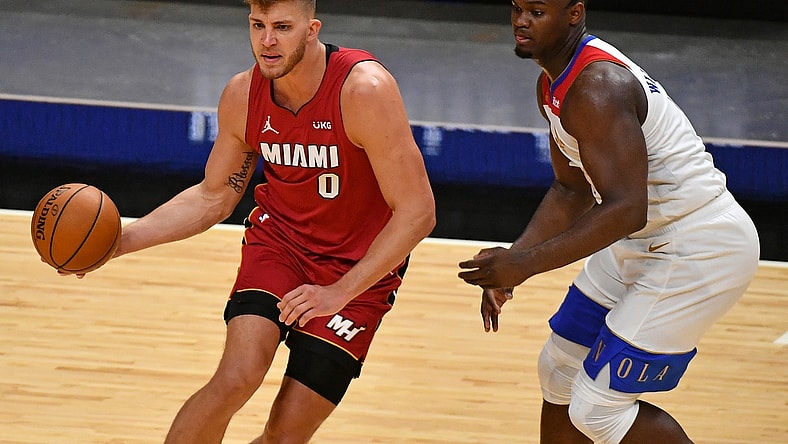 Dec 25, 2020; Miami, Florida, USA; Miami Heat center Meyers Leonard (0) controls the ball around New Orleans Pelicans forward Zion Williamson (1) during the second half at American Airlines Arena. Mandatory Credit: Jasen Vinlove-USA TODAY Sports