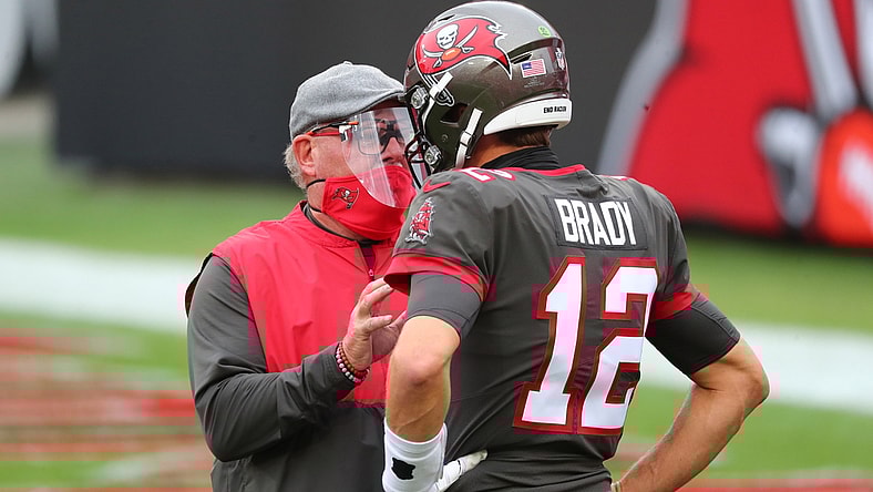 Jan 3, 2021; Tampa, Florida, USA; Tampa Bay Buccaneers head coach Bruce Arians (L) and quarterback Tom Brady (12) talk prior to the game against the Atlanta Falcons at Raymond James Stadium. Mandatory Credit: Kim Klement-USA TODAY Sports