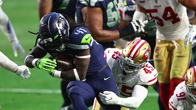 Jan 3, 2021; Glendale, Arizona, USA; Seattle Seahawks running back Alex Collins (41) is tackled by San Francisco 49ers linebacker Demetrius Flannigan-Fowles (45) at State Farm Stadium. Mandatory Credit: Mark J. Rebilas-USA TODAY Sports
