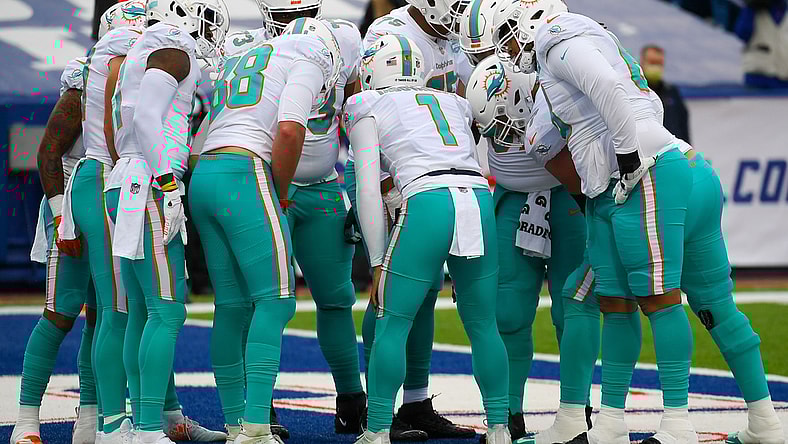 Jan 3, 2021; Orchard Park, New York, USA; Miami Dolphins quarterback Tua Tagovailoa (1) calls a play in the huddle against the Buffalo Bills during the first quarter at Bills Stadium. Mandatory Credit: Rich Barnes-USA TODAY Sports