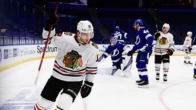 Jan 15, 2021; Tampa, Florida, USA; Chicago Blackhawks left wing Alex DeBrincat (12) reacts after scoring during the second period against the Tampa Bay Lightning at Amalie Arena. Mandatory Credit: Douglas DeFelice-USA TODAY Sports