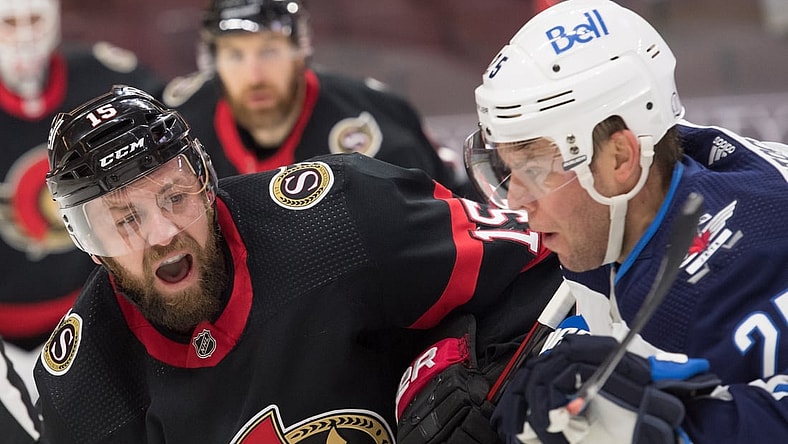 Jan 19, 2021; Ottawa, Ontario, CAN; Ottawa Senators center Derek Stepan (15) faces off against Winnipeg Jets center Paul Stastny (25) in the first period at the Canadian Tire Centre. Mandatory Credit: Marc DesRosiers-USA TODAY Sports