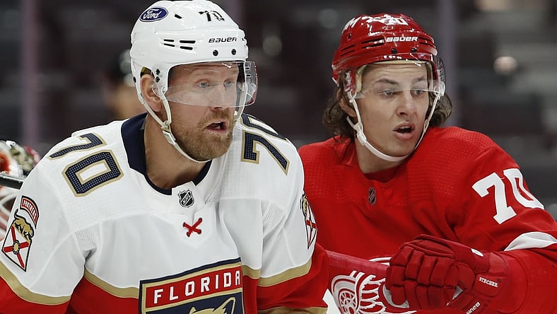 Jan 31, 2021; Detroit, Michigan, USA; Florida Panthers right wing Patric Hornqvist (left) fights for position in front of the net against Detroit Red Wings defenseman Troy Stecher (right) during the third period at Little Caesars Arena. Mandatory Credit: Raj Mehta-USA TODAY Sports