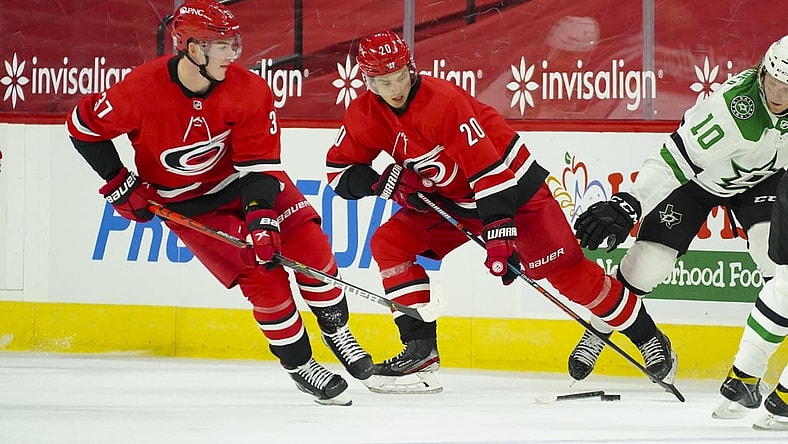Jan 31, 2021; Raleigh, North Carolina, USA;  Carolina Hurricanes right wing Sebastian Aho (20) and right wing Andrei Svechnikov (37) skate with the puck against the Dallas Stars at PNC Arena. Mandatory Credit: James Guillory-USA TODAY Sports