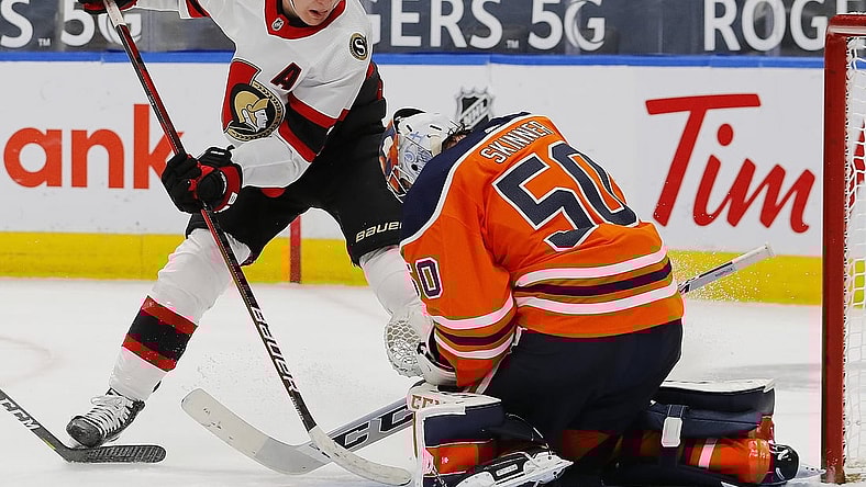 Jan 31, 2021; Edmonton, Alberta, CAN; Edmonton Oilers goaltender Stuart Skinner (50) makes a save against Ottawa Senators forward Brady Tkachuk (7) during the second period at Rogers Place. Mandatory Credit: Perry Nelson-USA TODAY Sports