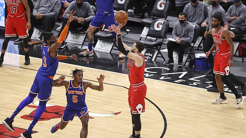 Feb 1, 2021; Chicago, Illinois, USA; Chicago Bulls guard Zach LaVine (8) shoots and scores a three-pointer against the New York Knicks during the second half of an NBA game at United Center. Mandatory Credit: Kamil Krzaczynski-USA TODAY Sports