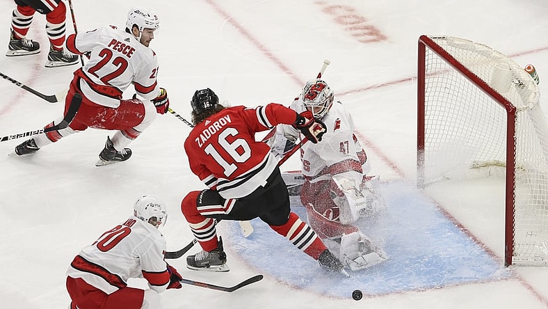 Feb 2, 2021; Chicago, Illinois, USA; Carolina Hurricanes goaltender James Reimer (47) defends against Chicago Blackhawks defenseman Nikita Zadorov (16) during the second period at United Center. Mandatory Credit: Kamil Krzaczynski-USA TODAY Sports