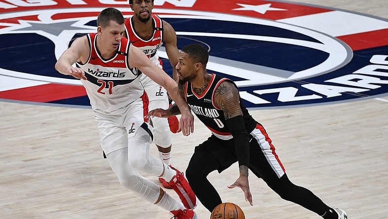 Feb 2, 2021; Washington, District of Columbia, USA; Portland Trail Blazers guard Damian Lillard (0) dribbles as Washington Wizards center Moritz Wagner (21) defends during the third quarter at Capital One Arena. Mandatory Credit: Brad Mills-USA TODAY Sports