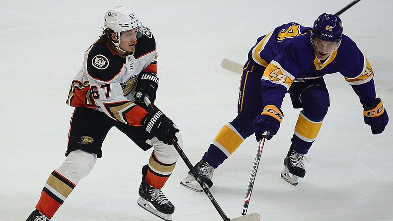 Feb 2, 2021; Los Angeles, California, USA; Anaheim Ducks center Rickard Rakell (67) passes the puck against Los Angeles Kings defenseman Mikey Anderson (44) during the first period at Staples Center. Mandatory Credit: Gary A. Vasquez-USA TODAY Sports
