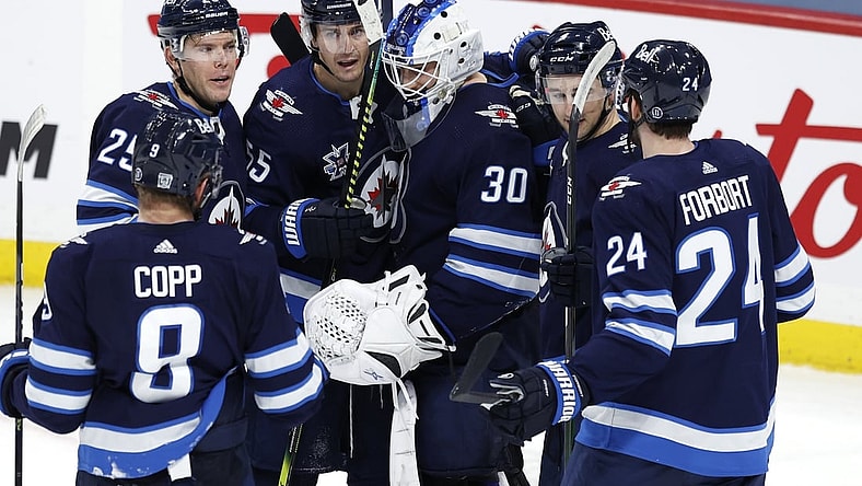 Feb 2, 2021; Winnipeg, Manitoba, CAN.;  Winnipeg Jets players celebrate their win against the Calgary Flames at Bell MTS Place. Mandatory Credit: James Carey Lauder-USA TODAY Sports