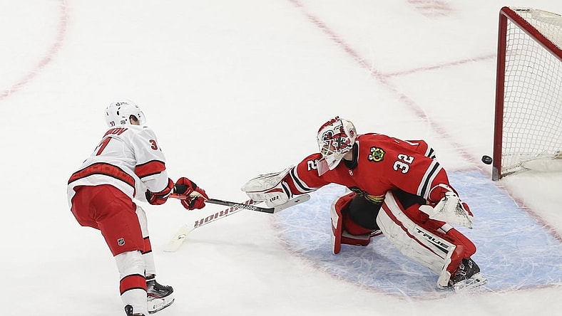 Feb 2, 2021; Chicago, Illinois, USA; Carolina Hurricanes right wing Andrei Svechnikov (37) scores a goal against Chicago Blackhawks goaltender Kevin Lankinen (32) during a shoot-out at United Center. Mandatory Credit: Kamil Krzaczynski-USA TODAY Sports