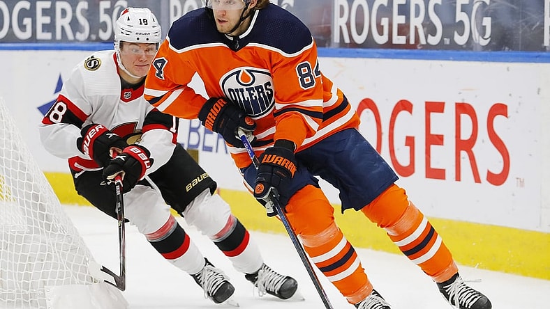 Feb 2, 2021; Edmonton, Alberta, CAN; Ottawa Senators forward Tim Stuetzle (18) chases Edmonton Oilers defensemen William Lagesson (84) during the second period at Rogers Place. Mandatory Credit: Perry Nelson-USA TODAY Sports