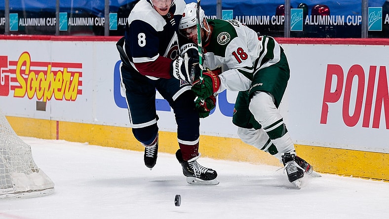 Feb 2, 2021; Denver, Colorado, USA; Colorado Avalanche defenseman Cale Makar (8) and Minnesota Wild left wing Jordan Greenway (18) battle for the puck in the third period at Ball Arena. Mandatory Credit: Isaiah J. Downing-USA TODAY Sports