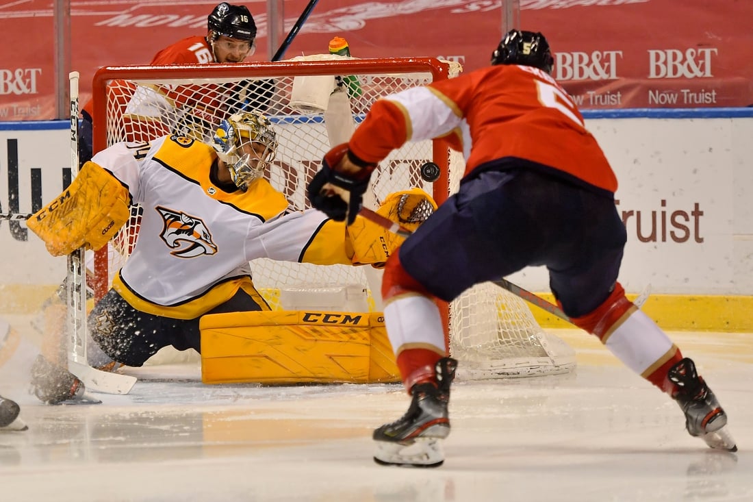 Feb 4, 2021; Sunrise, Florida, USA; Florida Panthers defenseman Aaron Ekblad (5) scores a goal past Nashville Predators goaltender Juuse Saros (74) during the second period at BB&T Center. Mandatory Credit: Jasen Vinlove-USA TODAY Sports