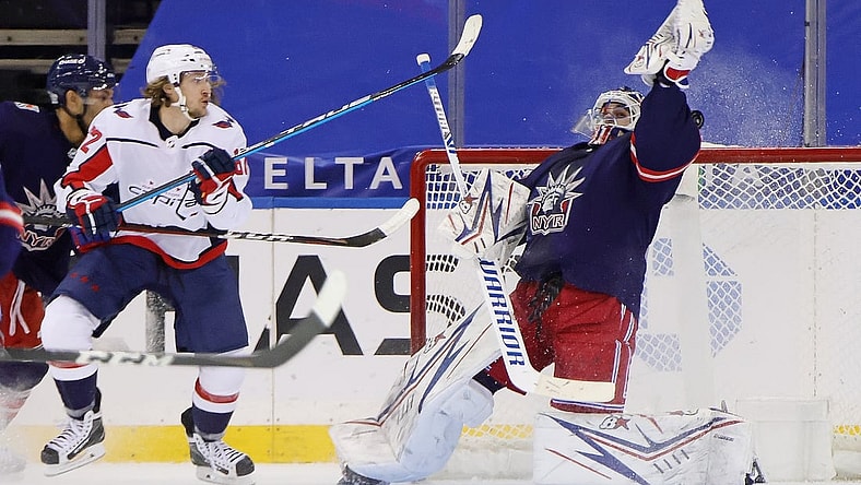 Feb 4, 2021; New York, NY, USA; Washington Capitals left wing Carl Hagelin (left) scores a goal against New York Rangers goaltender Igor Shesterkin (31) during the second period at Madison Square Garden. Mandatory Credit: Bruce Bennett/Pool Photo-USA TODAY Sports