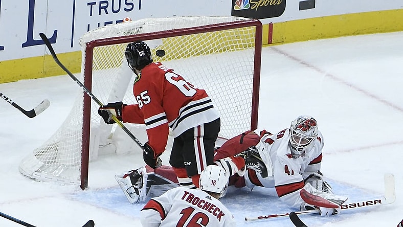 Feb 4, 2021; Chicago, Illinois, USA; Chicago Blackhawks right wing Andrew Shaw (65) scores a goal on Carolina Hurricanes goaltender James Reimer (47) during the first period at United Center. Mandatory Credit: David Banks-USA TODAY Sports