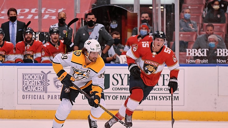 Feb 5, 2021; Sunrise, Florida, USA; Nashville Predators defenseman Roman Josi (59) skates with the puck past Florida Panthers center Noel Acciari (55) during the first period at BB&T Center. Mandatory Credit: Jasen Vinlove-USA TODAY Sports