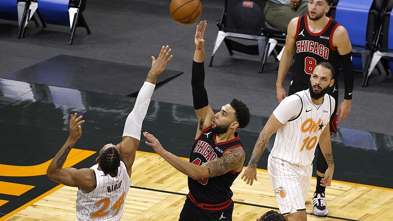 Feb 5, 2021; Orlando, Florida, USA; Chicago Bulls guard Denzel Valentine (45) shoots the ball between Orlando Magic guard Evan Fournier (10) and center Khem Birch (24) as  Bulls guard Zach LaVine (8) looks on during the second quarter at Amway Center. Mandatory Credit: Reinhold Matay-USA TODAY Sports