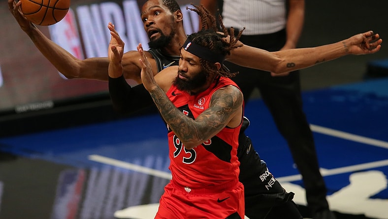 Feb 5, 2021; Brooklyn, New York, USA; Brooklyn Nets power forward Kevin Durant (7) tries to keep a ball in bounds against Toronto Raptors small forward DeAndre' Bembry (95) during the first quarter at Barclays Center. Mandatory Credit: Brad Penner-USA TODAY Sports