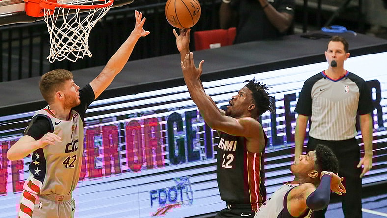 Feb 5, 2021; Miami, Florida, USA; Miami Heat forward Jimmy Butler (22) shoot a layup over Washington Wizards forward Davis Bertans (42) during the first quarter of the game at American Airlines Arena. Mandatory Credit: Sam Navarro-USA TODAY Sports