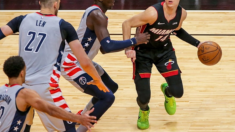 Feb 5, 2021; Miami, Florida, USA; Miami Heat guard Tyler Herro (14) dribbles the basketball around Washington Wizards forward Isaac Bonga (17) during the third quarter of the game at American Airlines Arena. Mandatory Credit: Sam Navarro-USA TODAY Sports