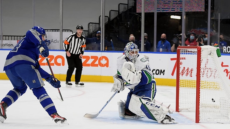 Feb 6, 2021; Toronto, Ontario, CAN;  Toronto Maple Leafs forward Auston Matthews (34) scores past Vancouver Canucks goalie Braden Holtby (49) in the first period at Scotiabank Arena. Mandatory Credit: Dan Hamilton-USA TODAY Sports