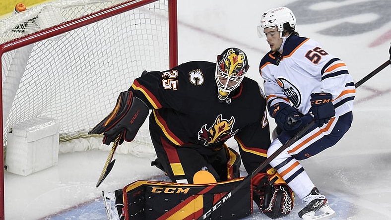 Feb 6, 2021; Calgary, Alberta, CAN; Calgary Flames goalie Jacob Markstrom (25) stops a shot from Edmonton Oilers forward Kailer Yamamoto (56) during the second period at Scotiabank Saddledome. Mandatory Credit: Candice Ward-USA TODAY Sports