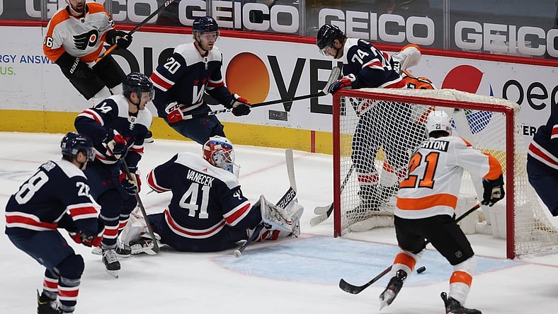 Feb 7, 2021; Washington, District of Columbia, USA; Philadelphia Flyers center Scott Laughton (21) scores a goal on Washington Capitals goaltender Vitek Vanecek (41) in the first period at Capital One Arena. Mandatory Credit: Geoff Burke-USA TODAY Sports