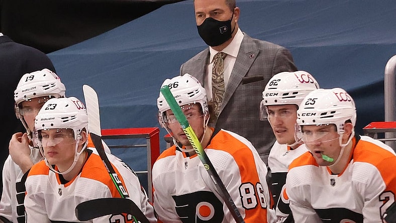 Feb 7, 2021; Washington, District of Columbia, USA; Philadelphia Flyers head coach Alain Vigneault (M) looks on from behind the bench against the Washington Capitals in the third period at Capital One Arena. Mandatory Credit: Geoff Burke-USA TODAY Sports