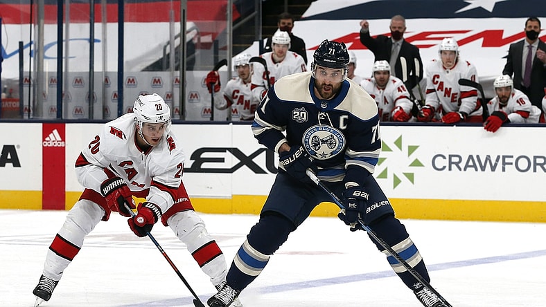 Feb 7, 2021; Columbus, Ohio, USA; Columbus Blue Jackets left wing Nick Foligno (71) looks to pass as Carolina Hurricanes right wing Sebastian Aho (20) pursues during the third period at Nationwide Arena. Mandatory Credit: Russell LaBounty-USA TODAY Sports