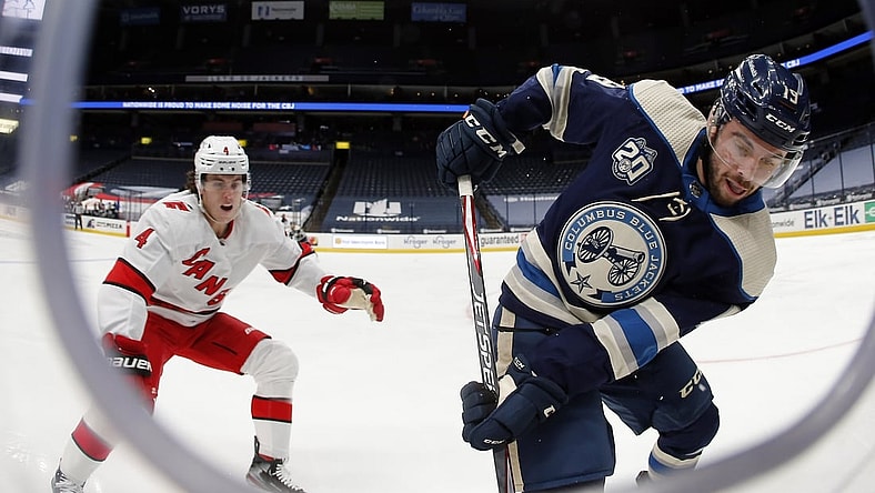 Feb 7, 2021; Columbus, Ohio, USA; Columbus Blue Jackets center Liam Foudy (19) carries the puck as Carolina Hurricanes defenseman Haydn Fleury (4) defends during the third period at Nationwide Arena. Mandatory Credit: Russell LaBounty-USA TODAY Sports
