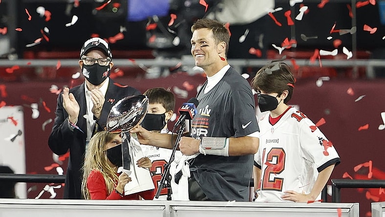 Feb 7, 2020; Tampa, FL, USA; Tampa Bay Buccaneers quarterback Tom Brady (12) hands the Lombardi Trophy to his children after Super Bowl LV at Raymond James Stadium.  Mandatory Credit: Kim Klement-USA TODAY Sports