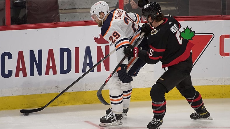 Feb 8, 2021; Ottawa, Ontario, CAN; Edmonton Oilers center Leon Draisaitl (29) skates with the puck in front of  Ottawa Senators defenseman Mike Reilly (5) in the third period at the Canadian Tire Centre. Mandatory Credit: Marc DesRosiers-USA TODAY Sports