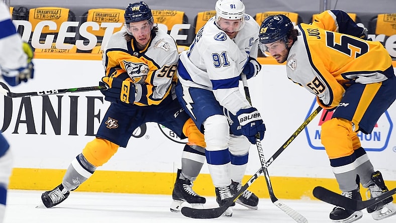 Feb 8, 2021; Nashville, Tennessee, USA; Tampa Bay Lightning center Steven Stamkos (91) works to get the puck against Nashville Predators left wing Erik Haula (56) and Nashville Predators defenseman Roman Josi (59) during the third period at Bridgestone Arena. Mandatory Credit: Christopher Hanewinckel-USA TODAY Sports